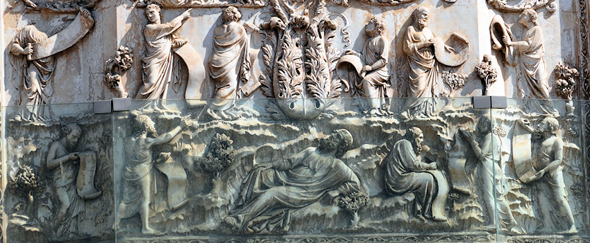 Marble wall panel with 12 men carved in it, 11 of them holding a scroll