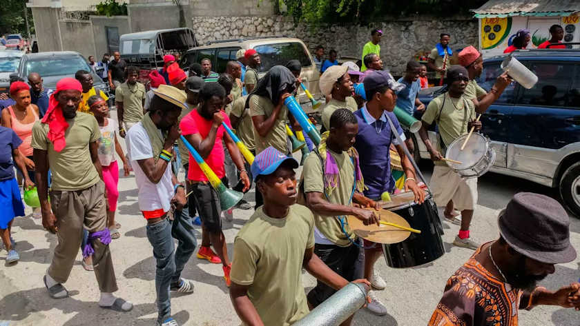 Colorfully dressed rara band with instruments in a Haitian street