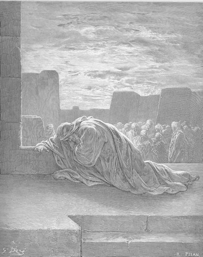 Robed figure in the foreground kneeling in prayer; people in the background watching