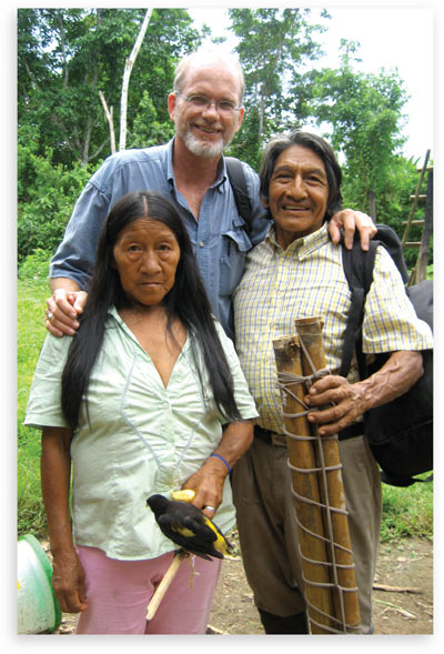 Steve Saint standing with a Waodani couple