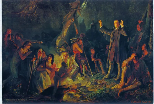 Missionary preaching to a crowd of Native Americans around a campfire