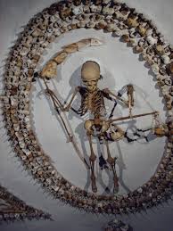 monks' bones used
to create a grim reaper on the wall of a church in Rome