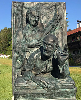 Bas relief sculpture of Gruber and Mohr leading the singing of Silent Night