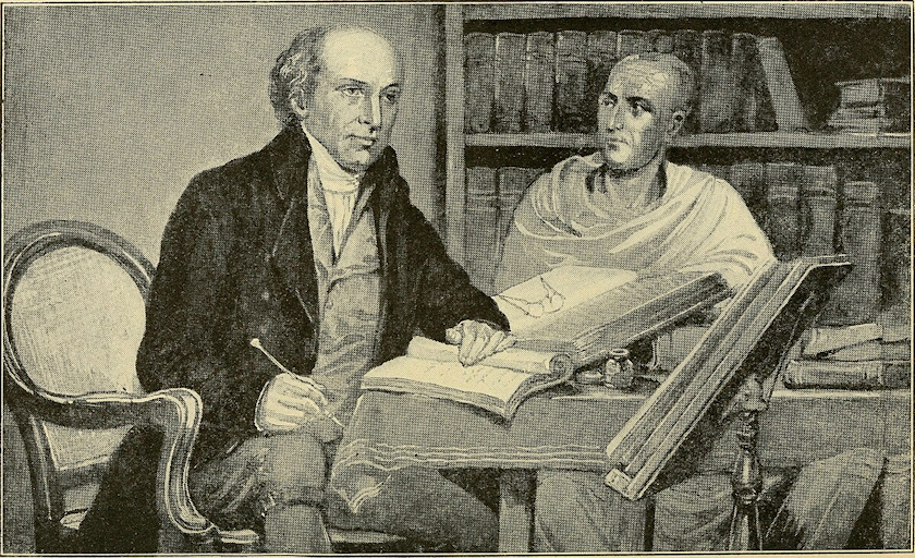 Two men seated at a table working on Bible translation