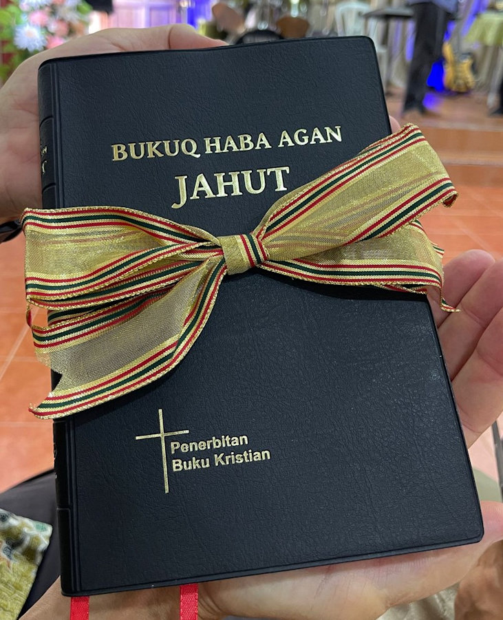 Foreign language Bible with a bow tied around it