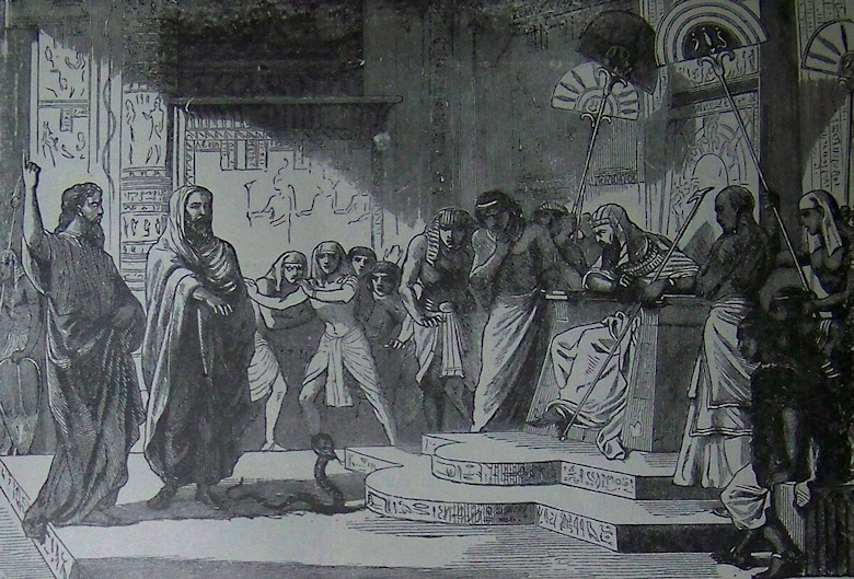 Moses and Aaron standing in front of Pharaoh who is seated and has a crowd of Egyptians around him