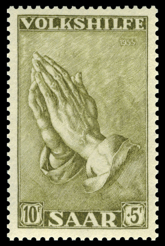 Praying hands design on postage stamp