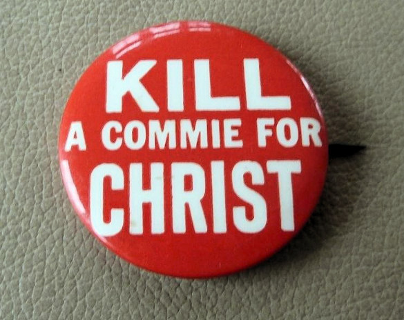 lapel button with kill a commie slogan on it