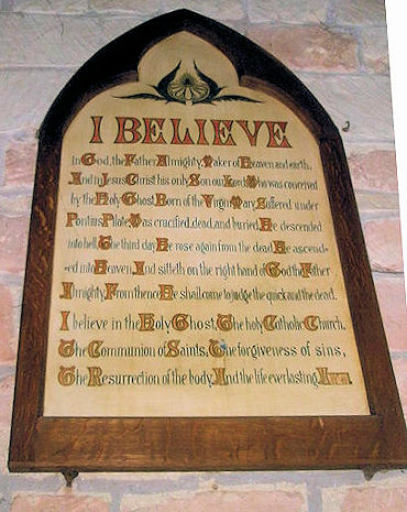 Apostles' Creed wording on plaque on a stone wall