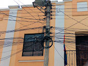 photo of jumble of
overhead wiring above street